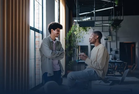 A group of happy employees chatting on their break in the office