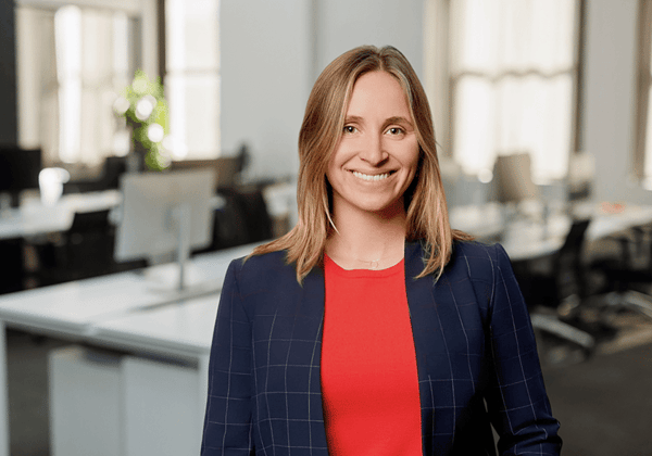 Headshot of Kara Thesing with empty office environment in background.