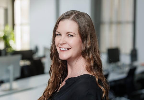 Headshot of April Crawford with empty office environment in background.