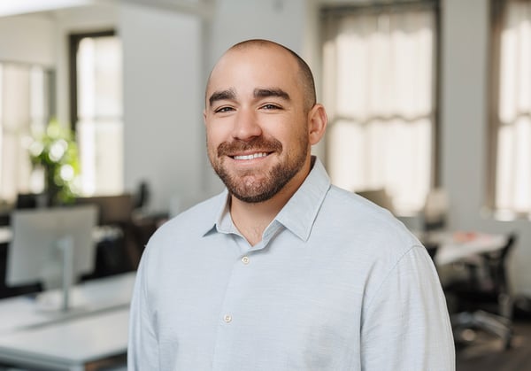 Headshot of Brent Roberts with empty office environment in background.