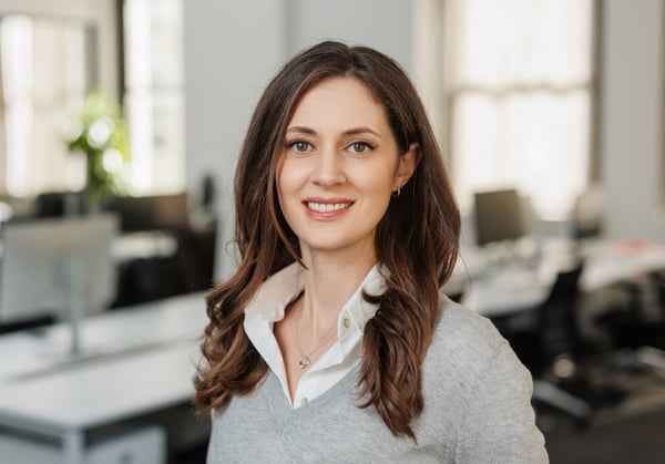 Headshot of Katie Bronnenkant with empty office environment in background.